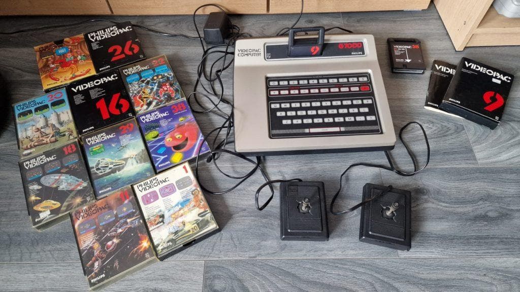 Philips Videopac computer with cartridges, controllers, and manuals